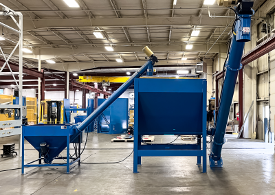 Power hopper, high capacity live bottom bin and screw conveyor combination to move material from shredder to extruder.