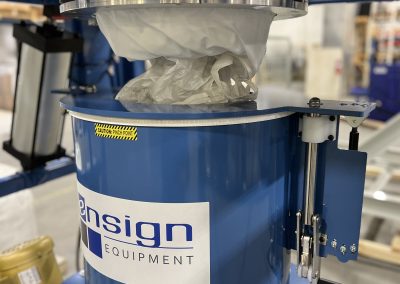 Iris valve for material flow control and dust-tight spout clamp seal for dust mitigation.