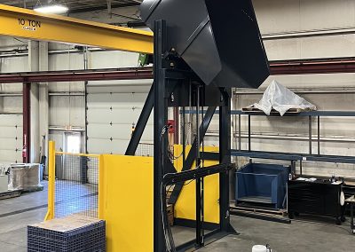 Extra-tall container dumper lifting a loaded container to a high discharge height, shown with a stable base, guarded moving components, and a clean, industrial design for safe and efficient material handling.