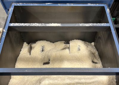 Agitator inside a high capacity live bottom bin to help material flow.