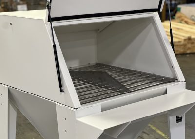 Inside the bag break station where a 50-pound sack is placed on a cutter blade and emptied.