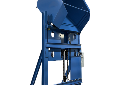 Standard lift and dump container dumper raising a loaded container to an elevated discharge height, shown with a sturdy frame, guarded moving components, and a clean industrial design for safe, efficient material handling.