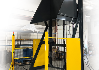 Extra-tall, wide container dumper designed for high-discharge material handling, featuring full safety guarding for operator protection.