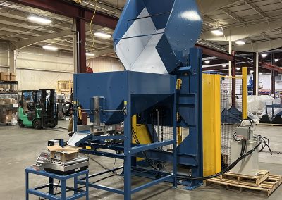 Small parts handling system featuring a UHMW-lined Gaylord dumper, hopper with adjustable discharge, and vibratory feeder integrated with an automated scale for precision fastener packaging. System engineered for smooth part flow, damage prevention, accurate piece count by weight, and enhanced operator safety.